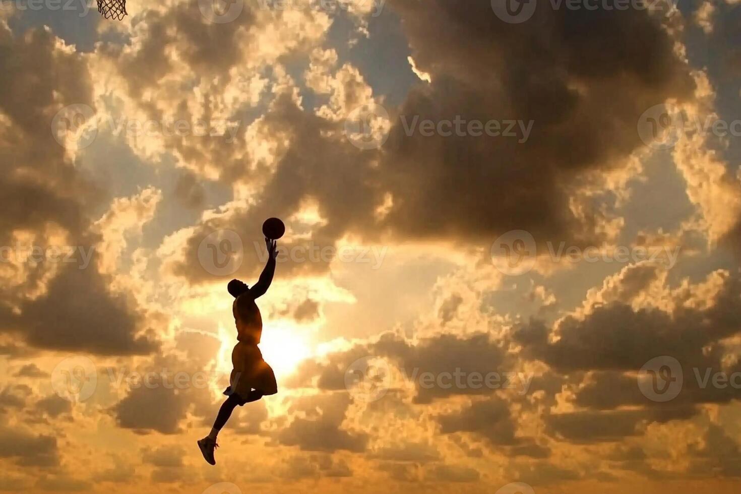 A man is jumping up to catch a basketball ball photo
