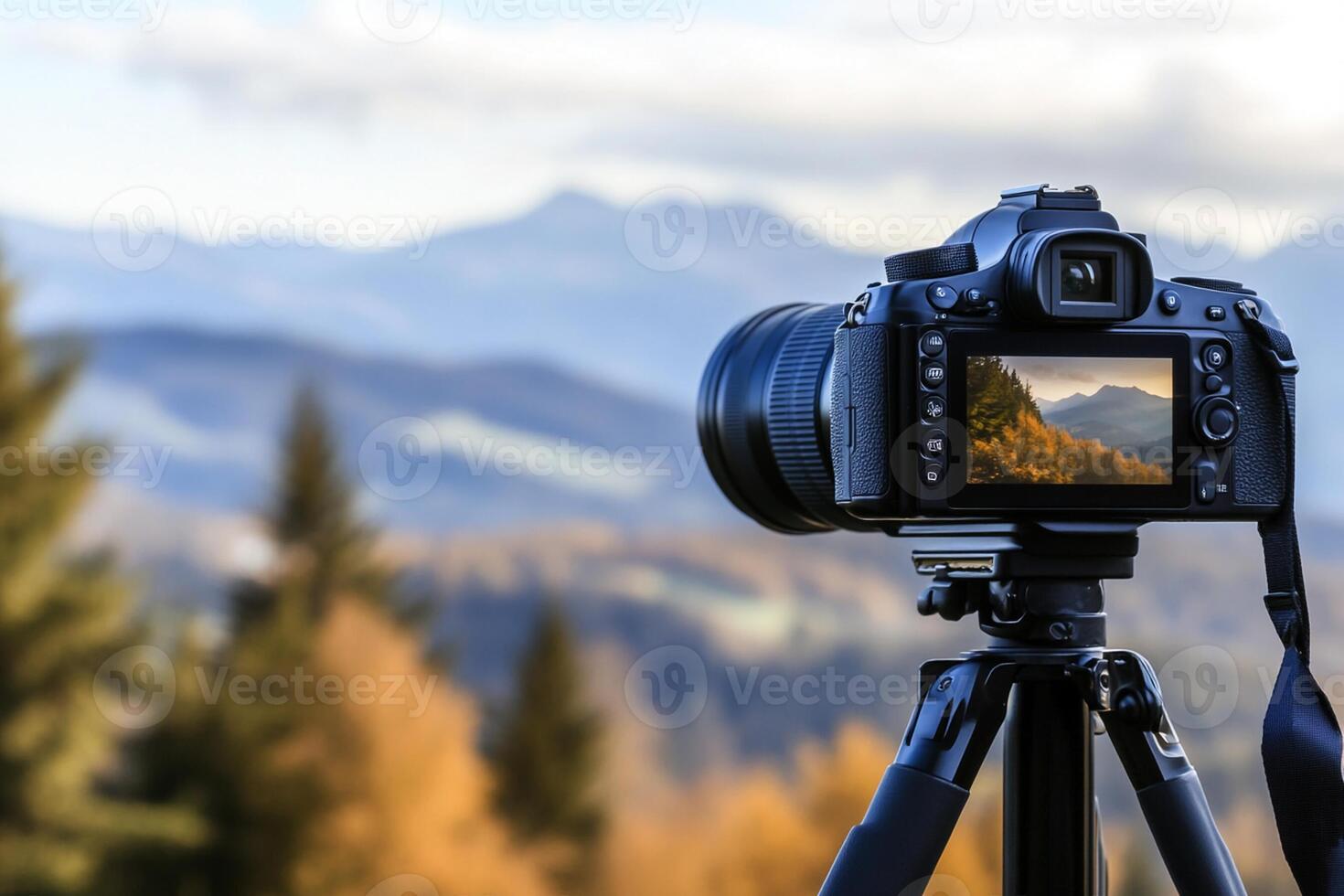 A camera on a tripod with mountains in the background photo