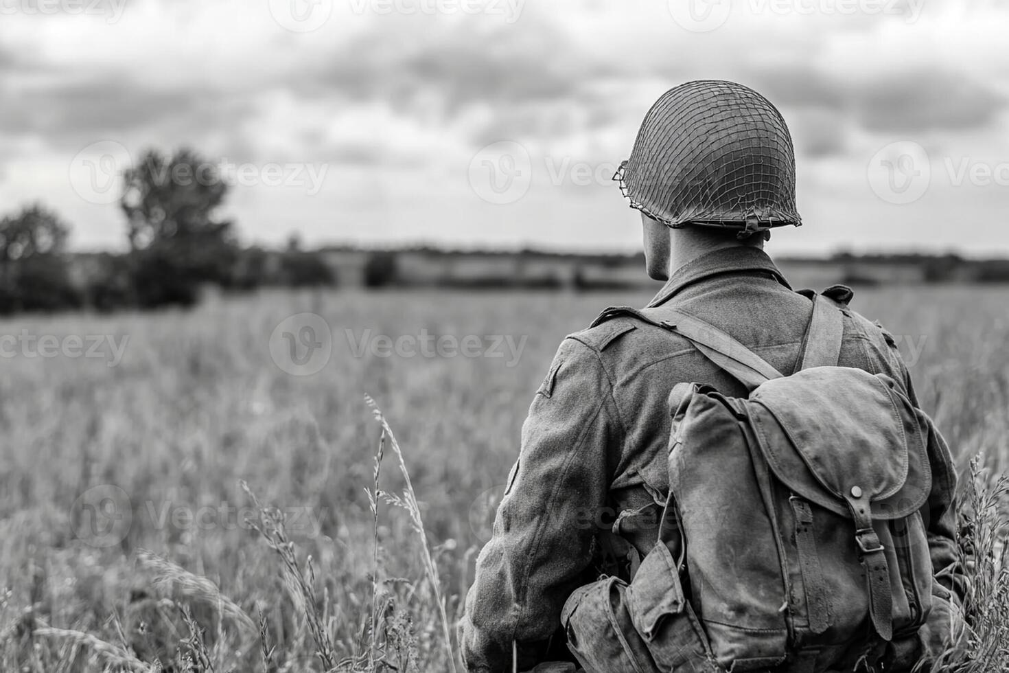 A soldier in a field with a backpack photo