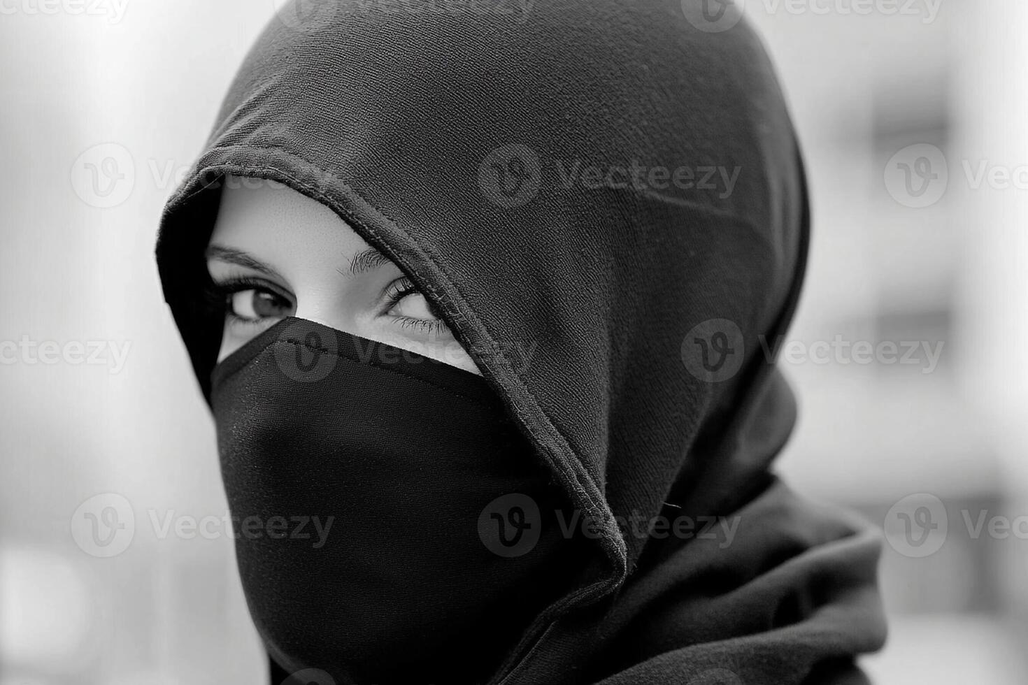 A woman wearing a black veil and a black hood photo