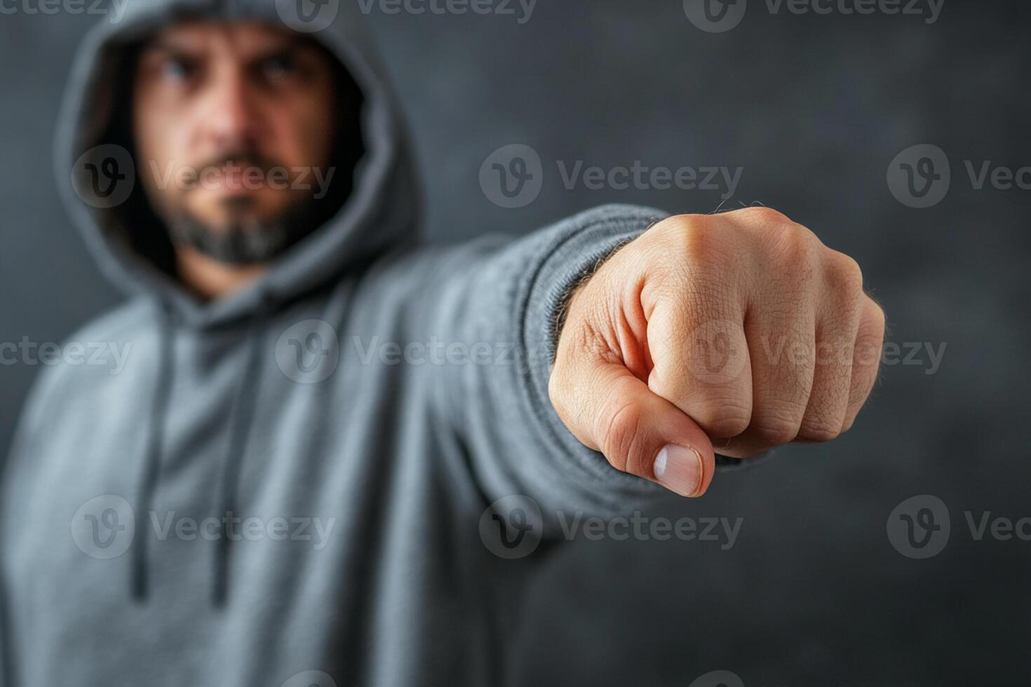 A man in a hoodie pointing at something photo