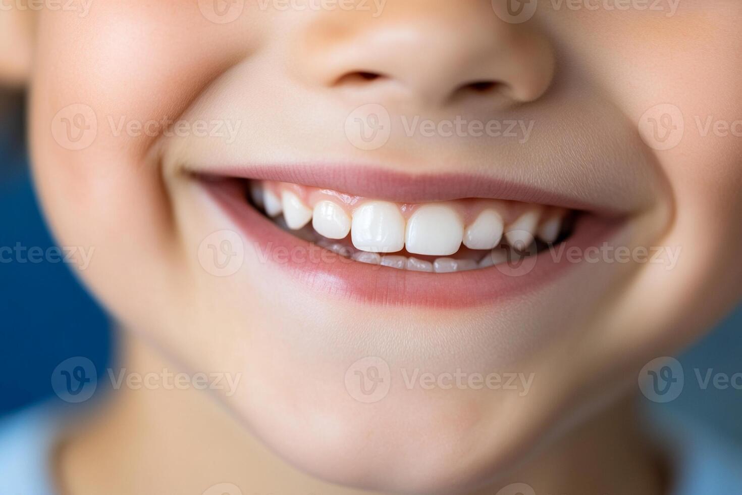 A close up of a child's smile with white teeth photo