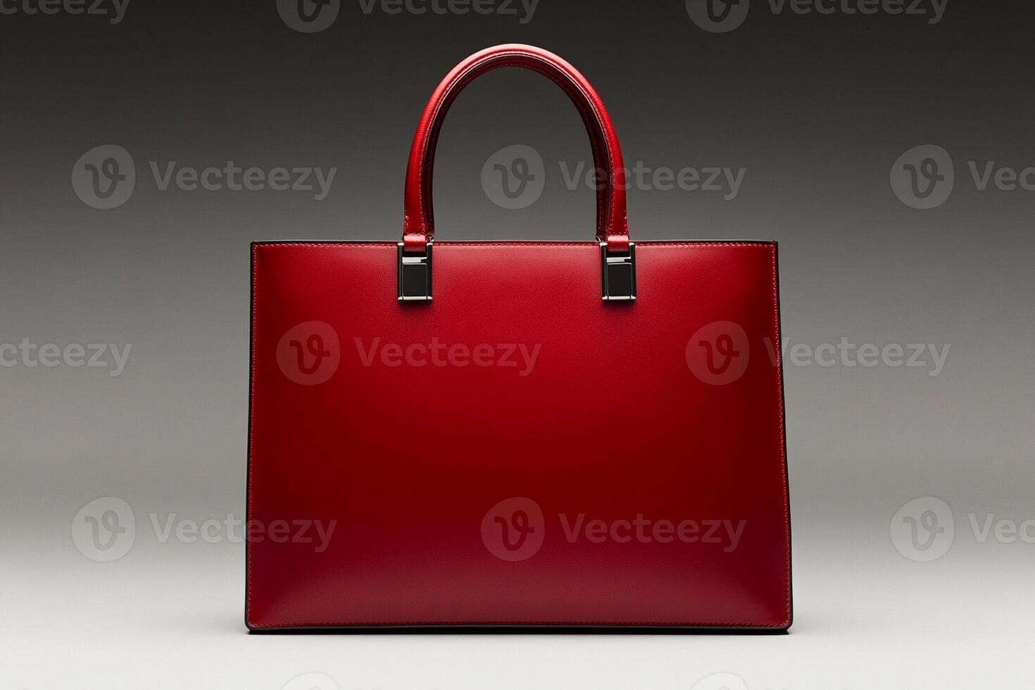 A red leather handbag on a grey background photo