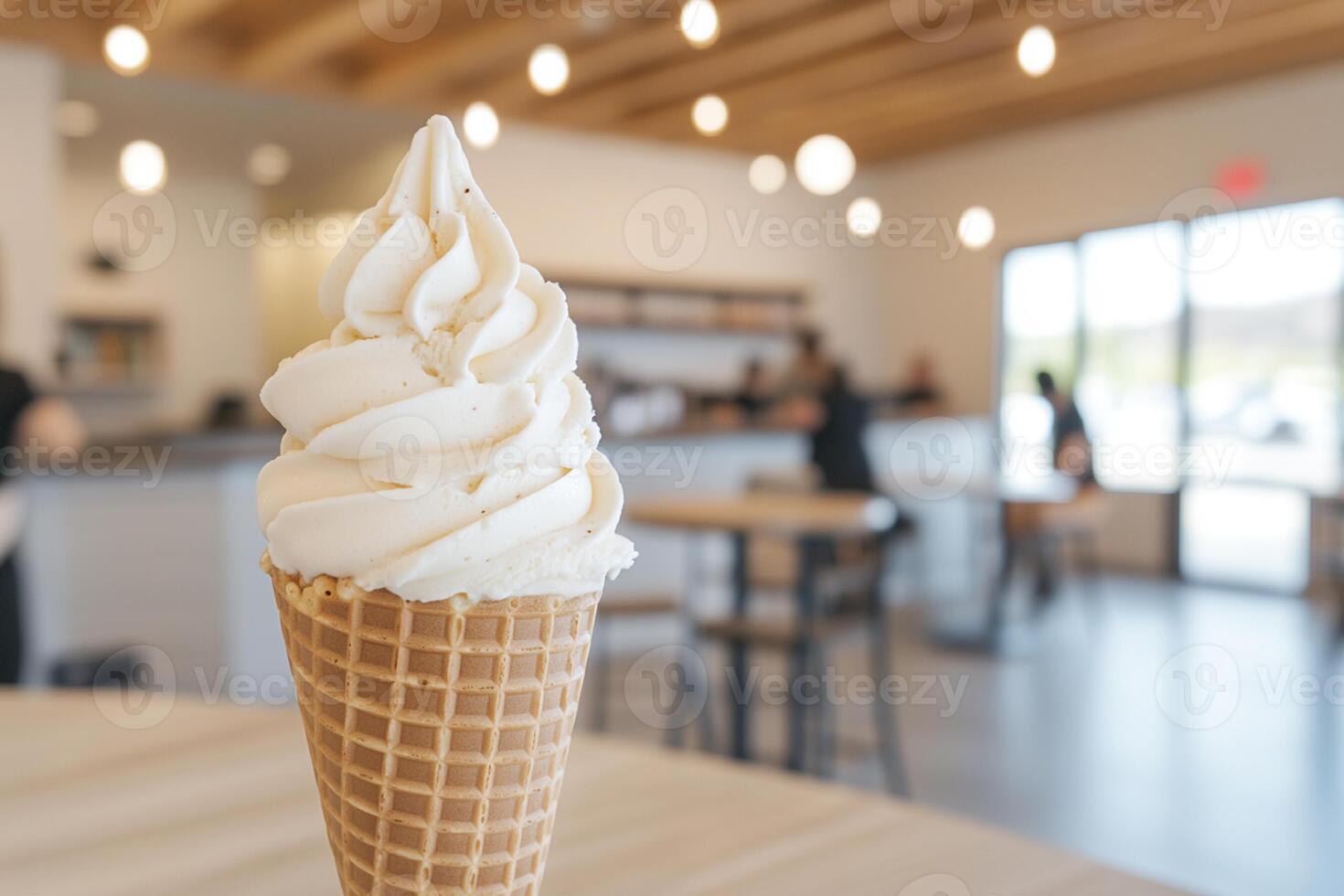 A waffle cone with whipped cream on top photo