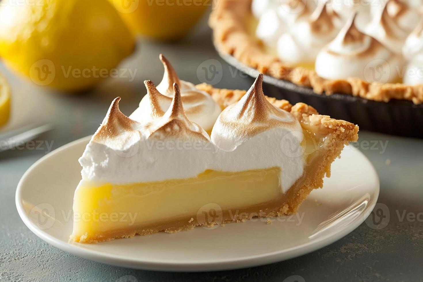 A slice of lemon meringue pie with a fork photo