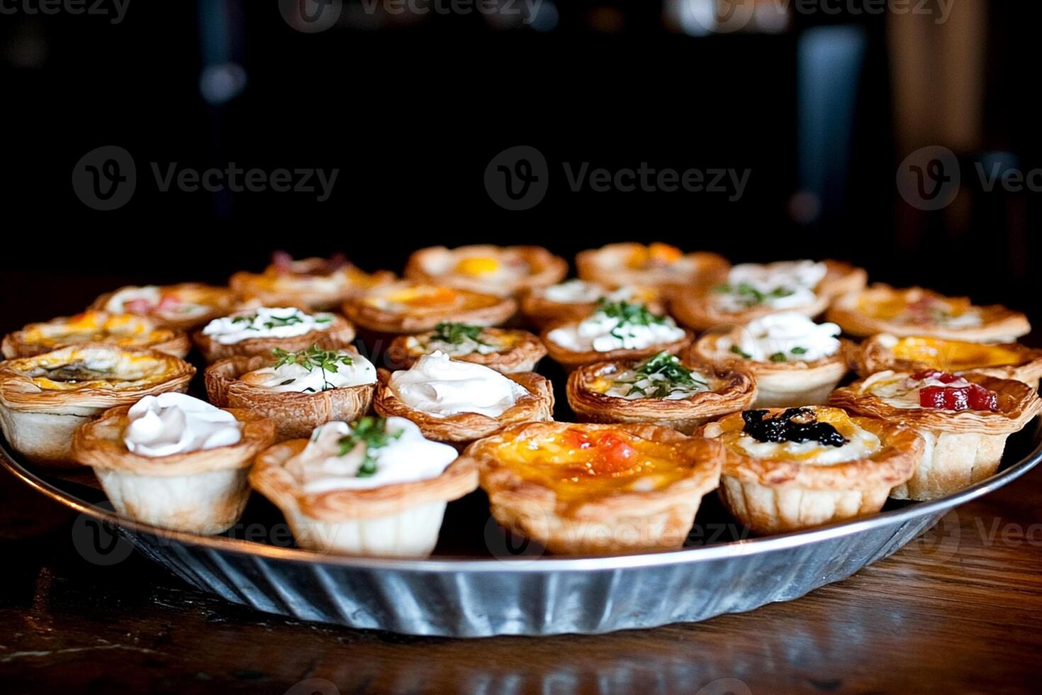 A tray of mini quiches on a wooden table photo