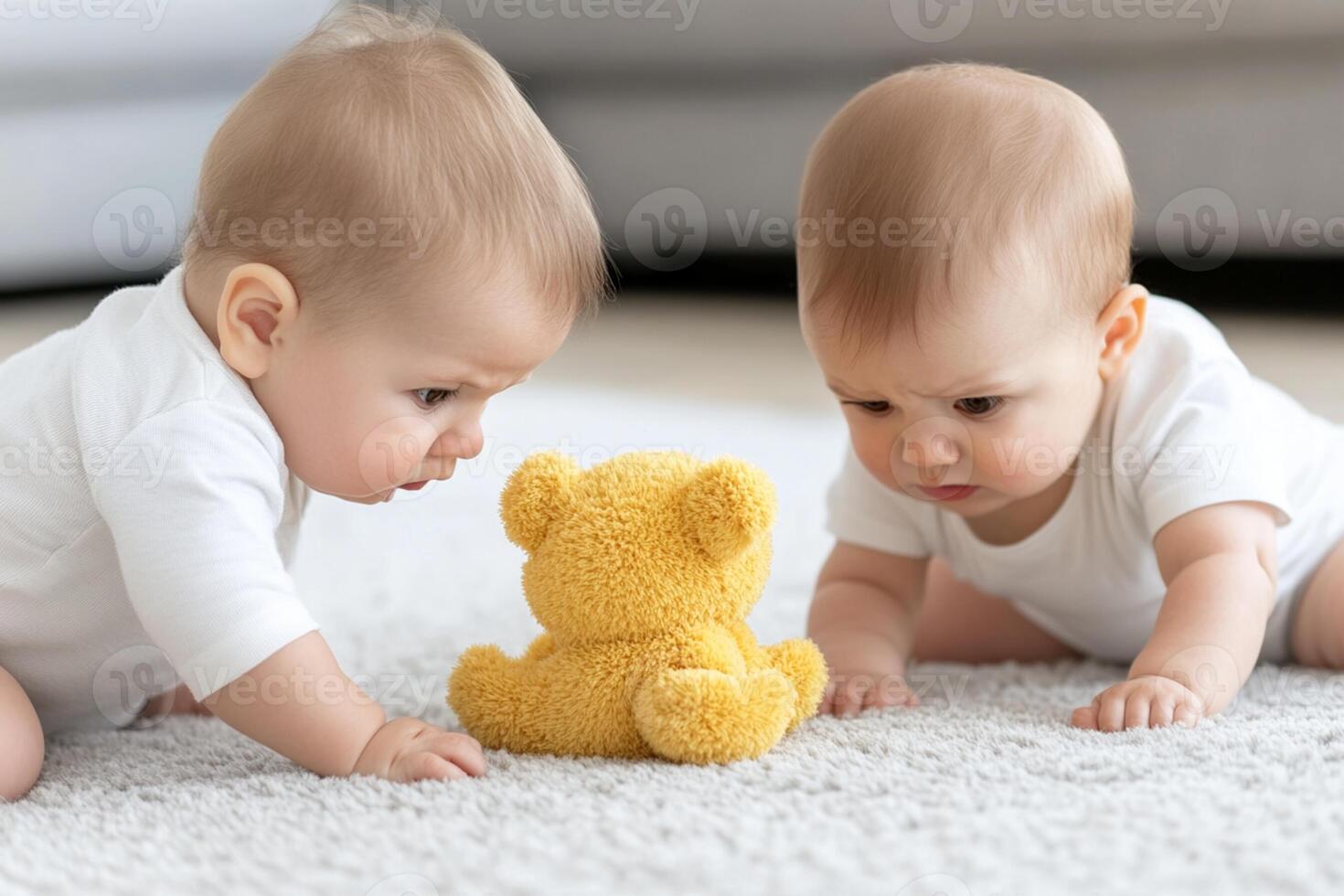 Two babies playing with a teddy bear photo