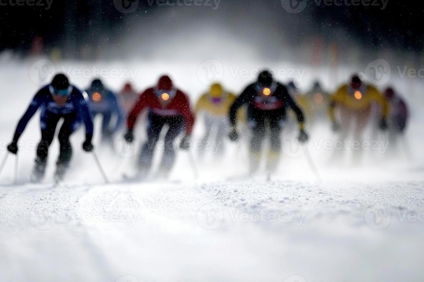 A group of skiers racing down a snowy slope photo