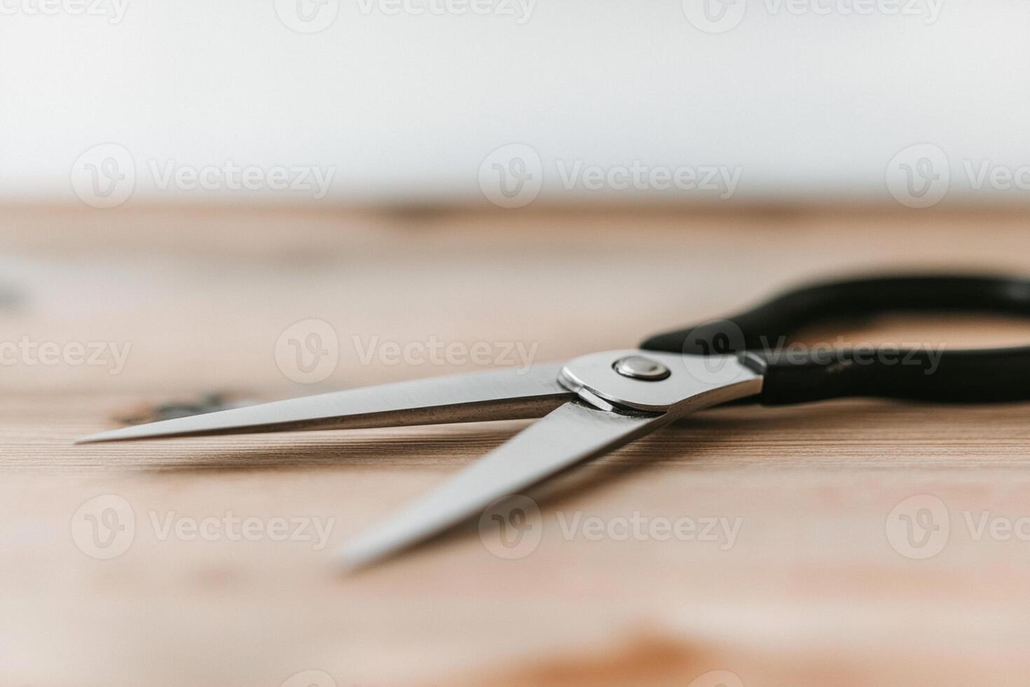 A pair of scissors on a wooden table photo