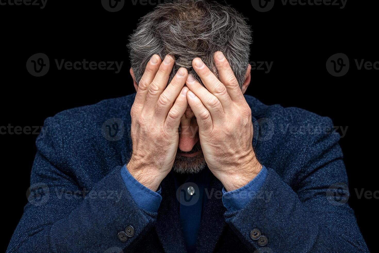 A man is holding his head in his hands photo