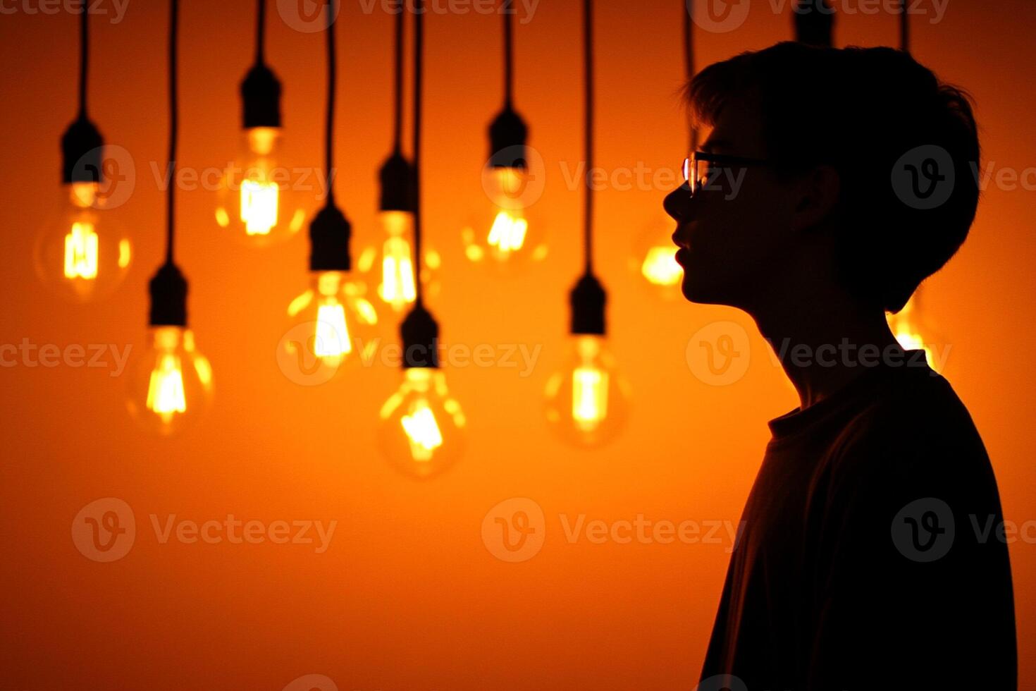 A man standing in front of a group of light bulbs photo