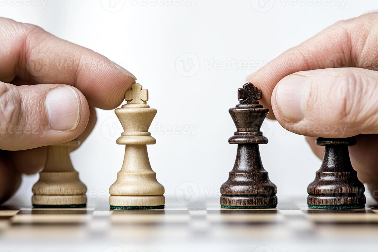 Two hands are holding chess pieces on a board photo