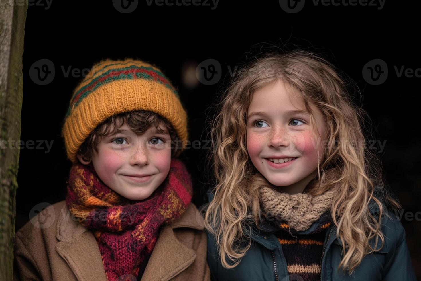 Two children wearing warm clothing pose for a photo