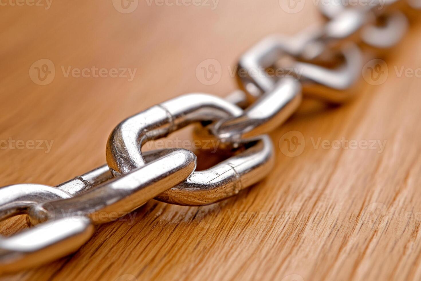 A close up of a chain link on a wooden surface photo
