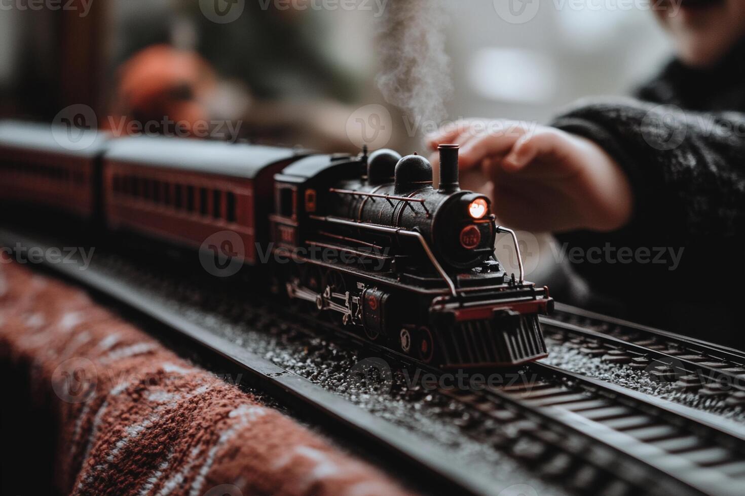 A child playing with a toy train on a table photo