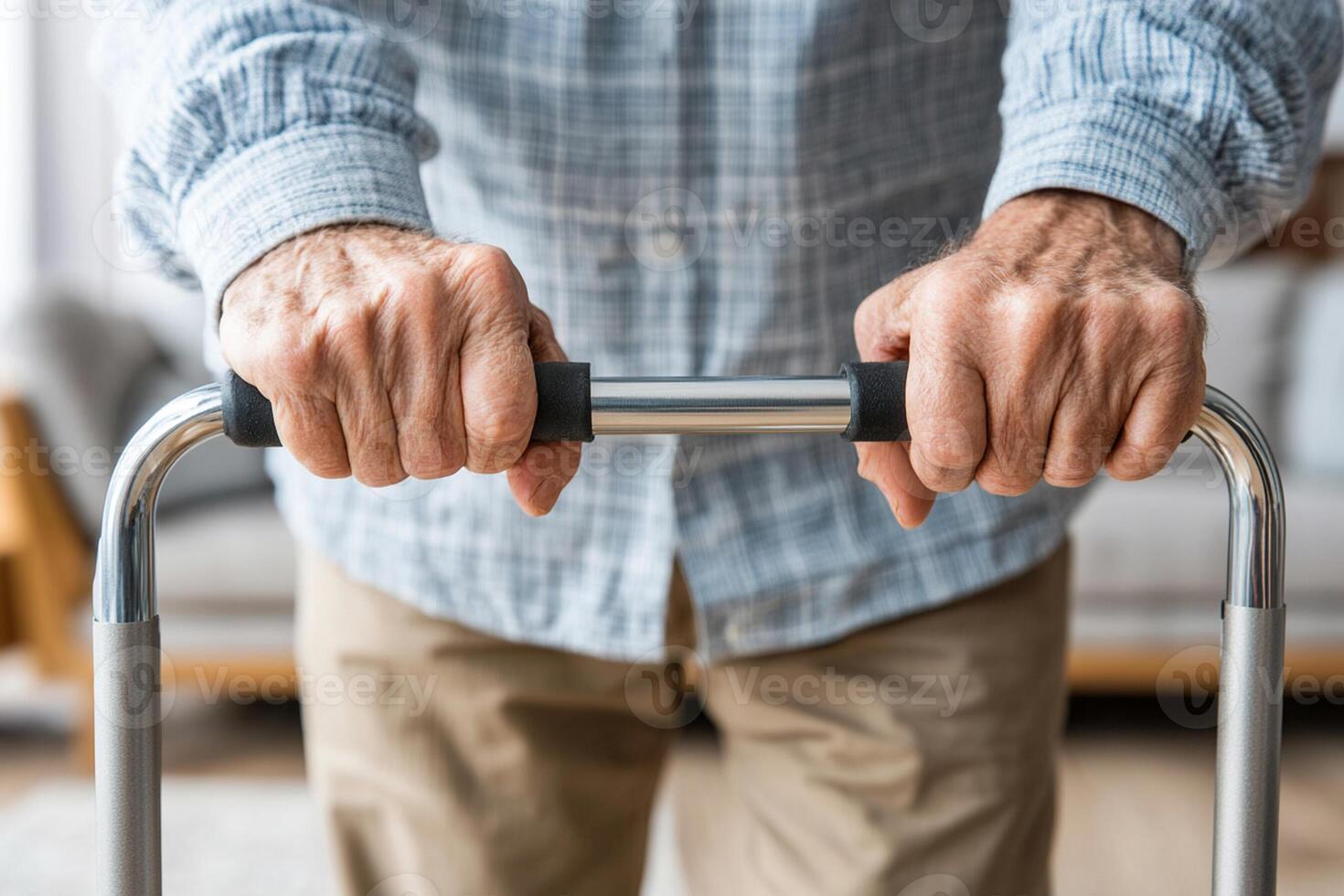 A close up of an elderly man's hands holding a walker photo