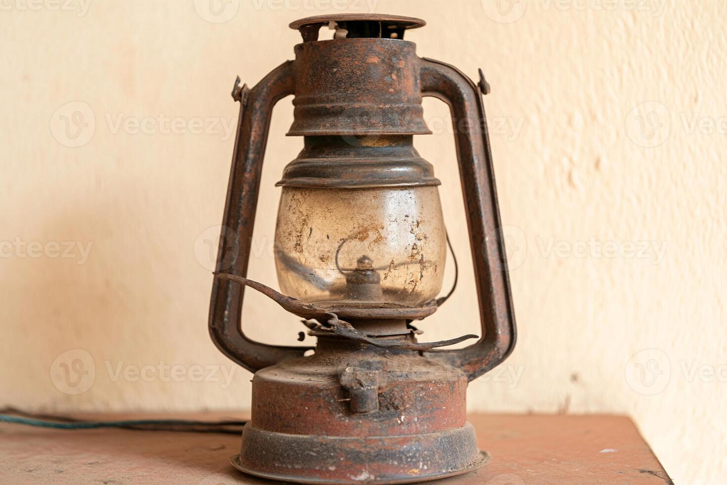 A small old fashioned lantern sitting on a table photo