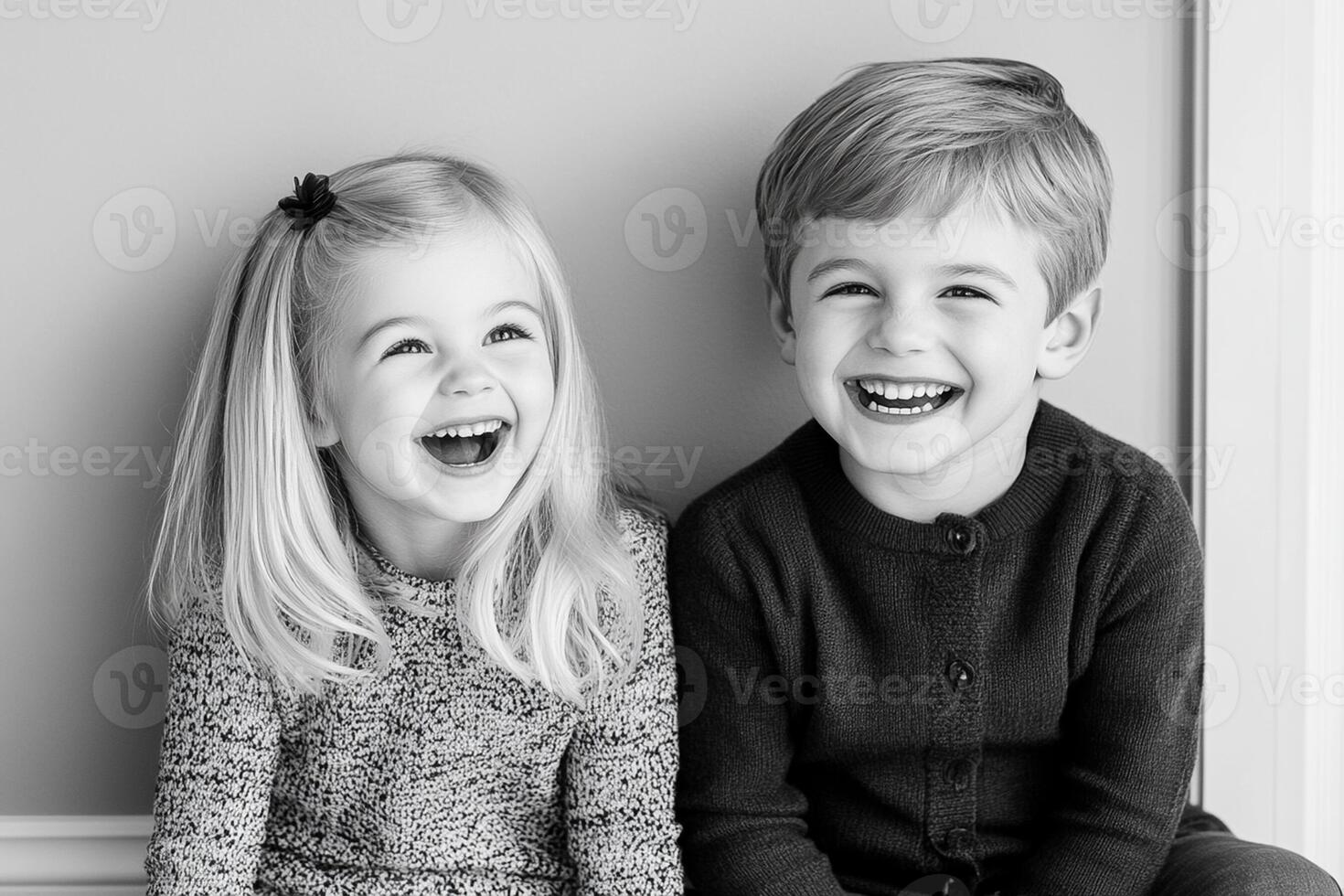 Two children laughing in black and white photo