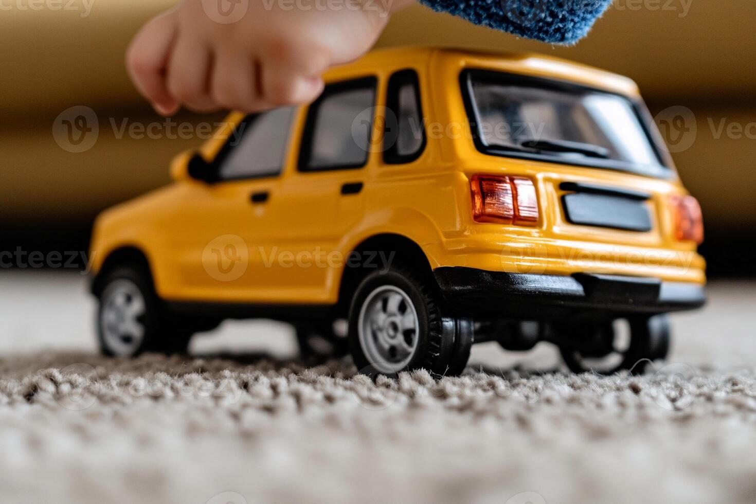 A child's hand is holding a toy car photo