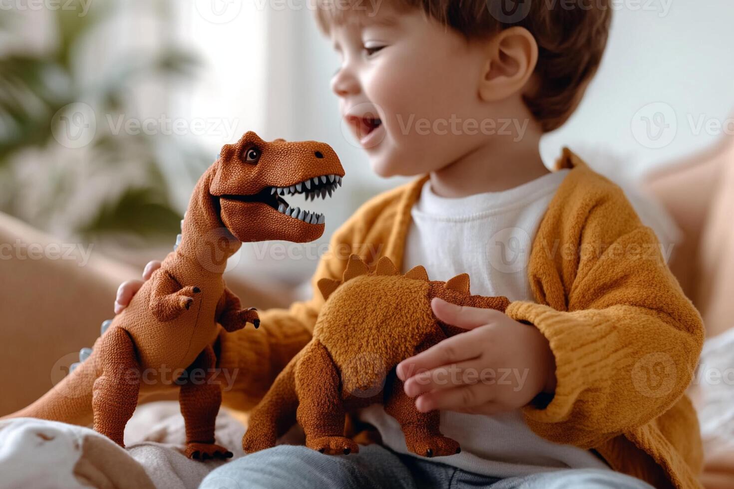 A young boy is playing with a dinosaur toy photo
