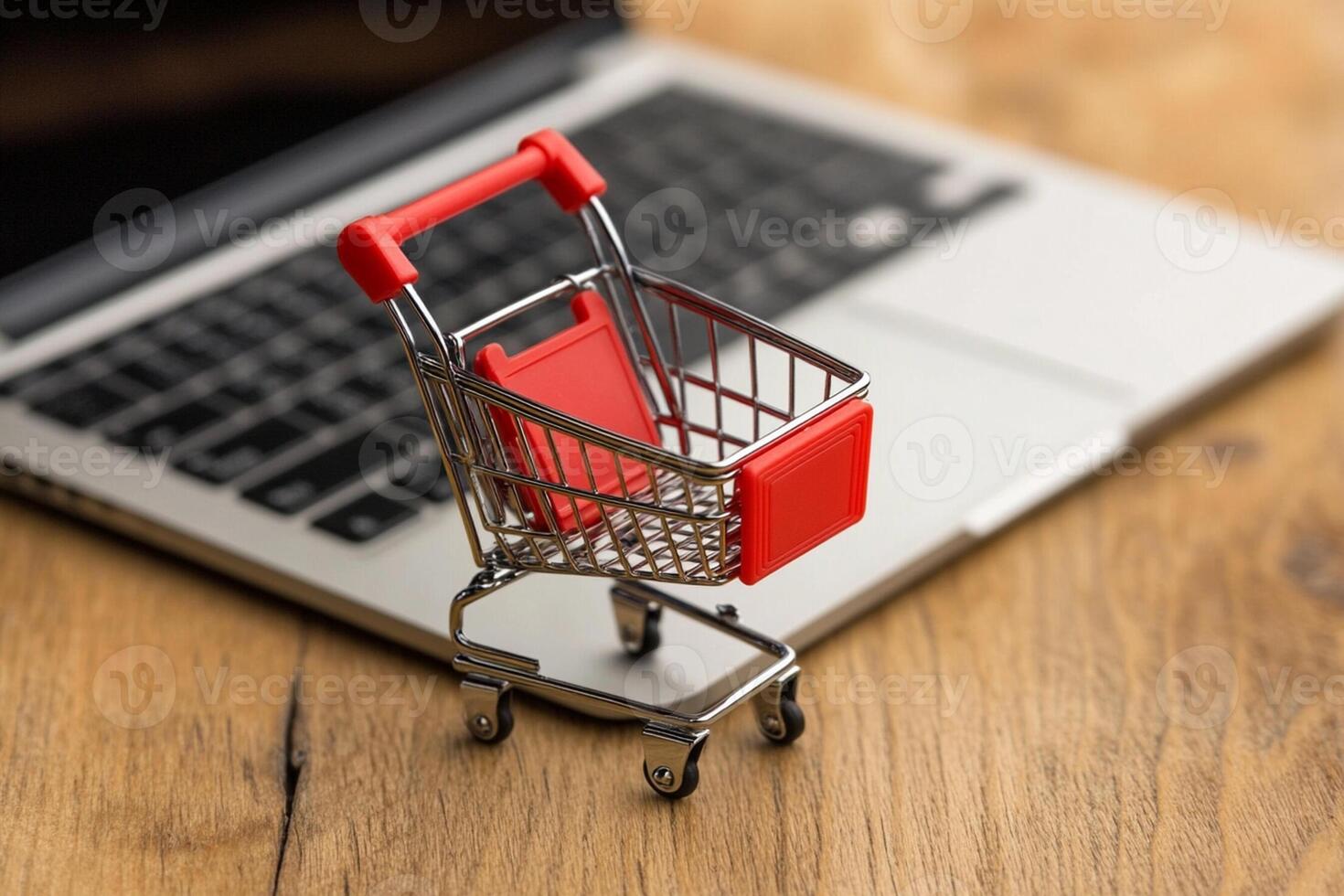 A small shopping cart is sitting on top of a laptop photo