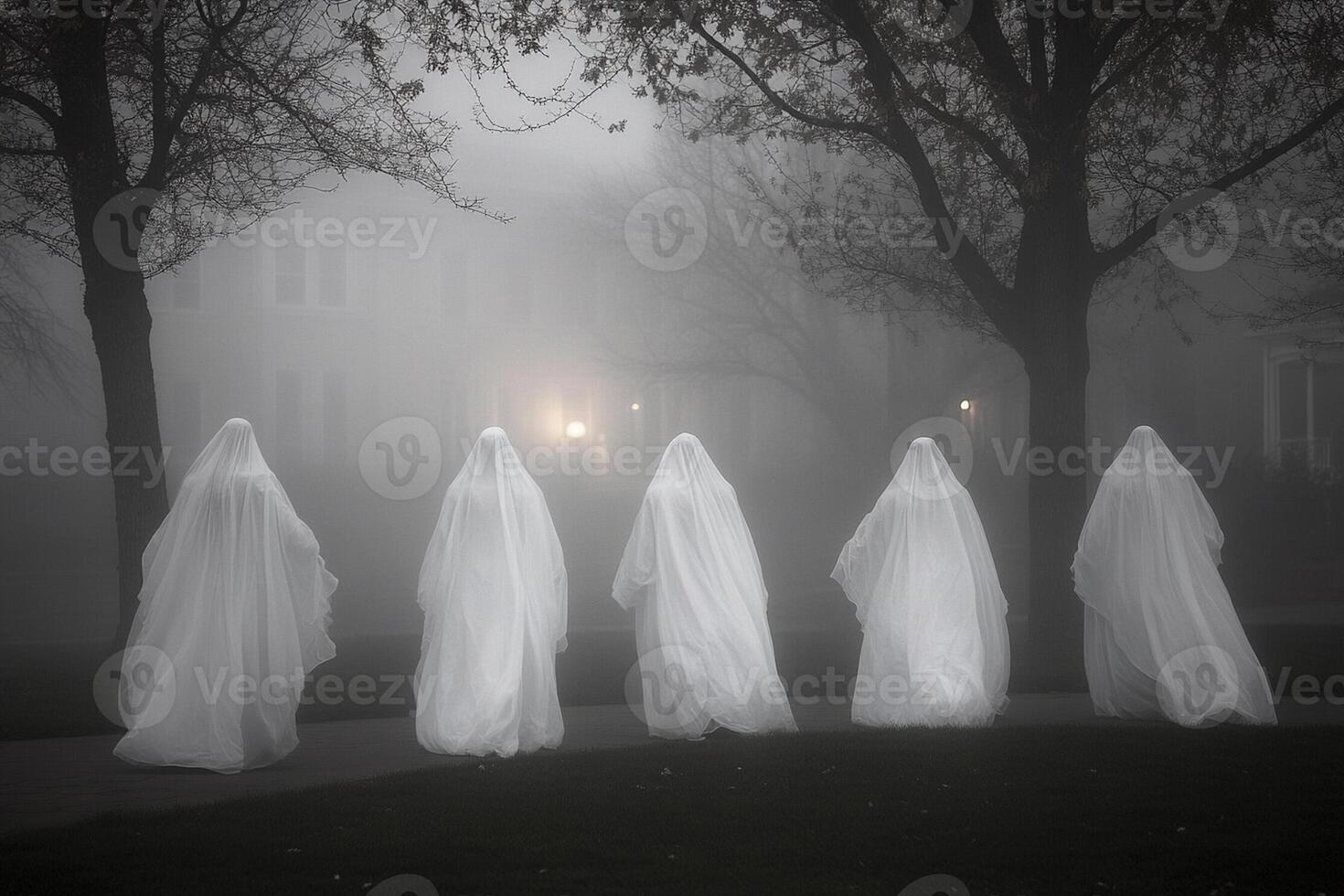 Five ghostly figures walk through the fog photo