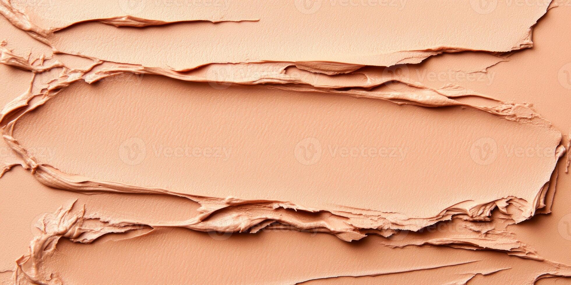 Various textured layers of beige foundation display intricate patterns. The warm tones and smooth surface combine for a creative, abstract effect in beauty products photo