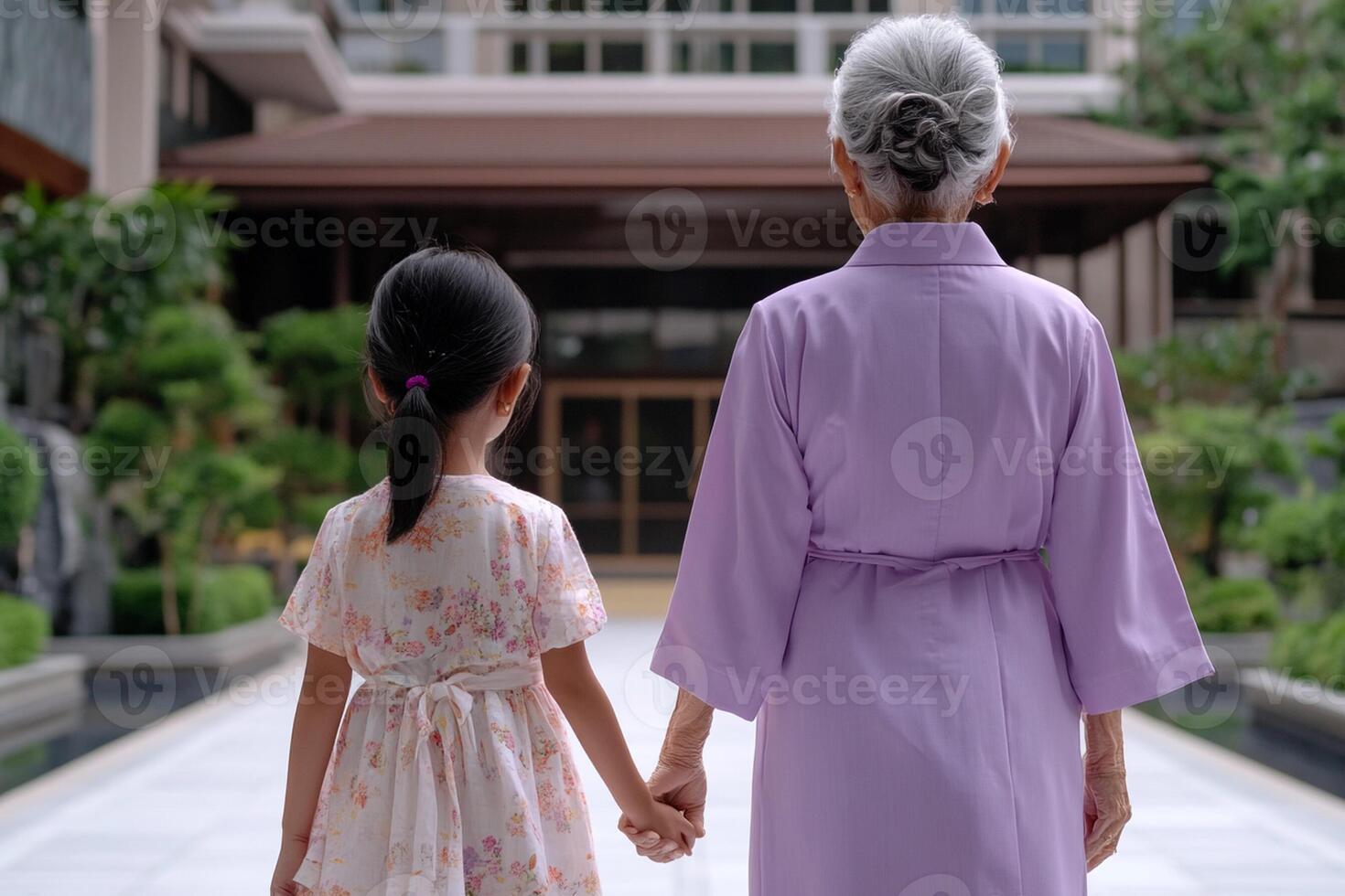 An older woman and young girl holding hands photo
