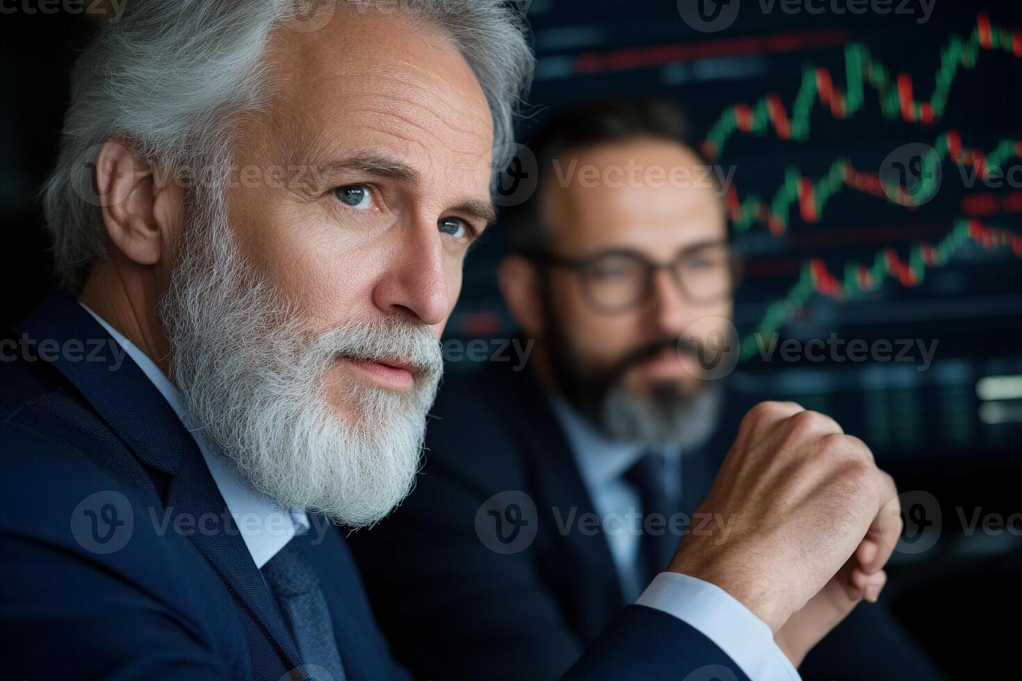 Two men in suits looking at a screen photo