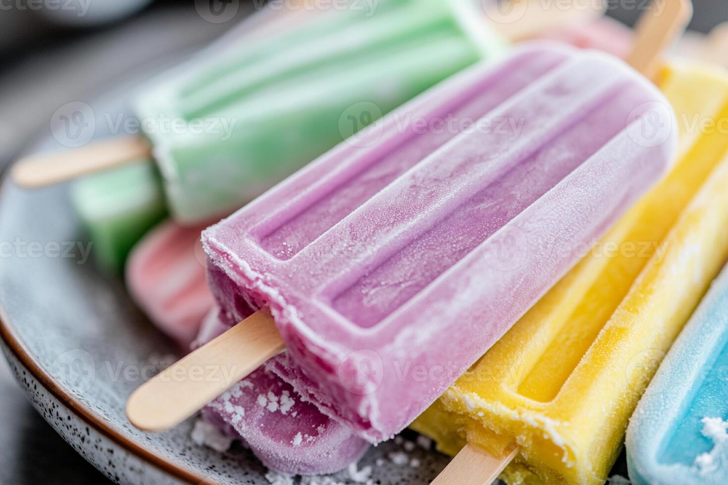 Popsicles are colorful and have different colored ice cream photo