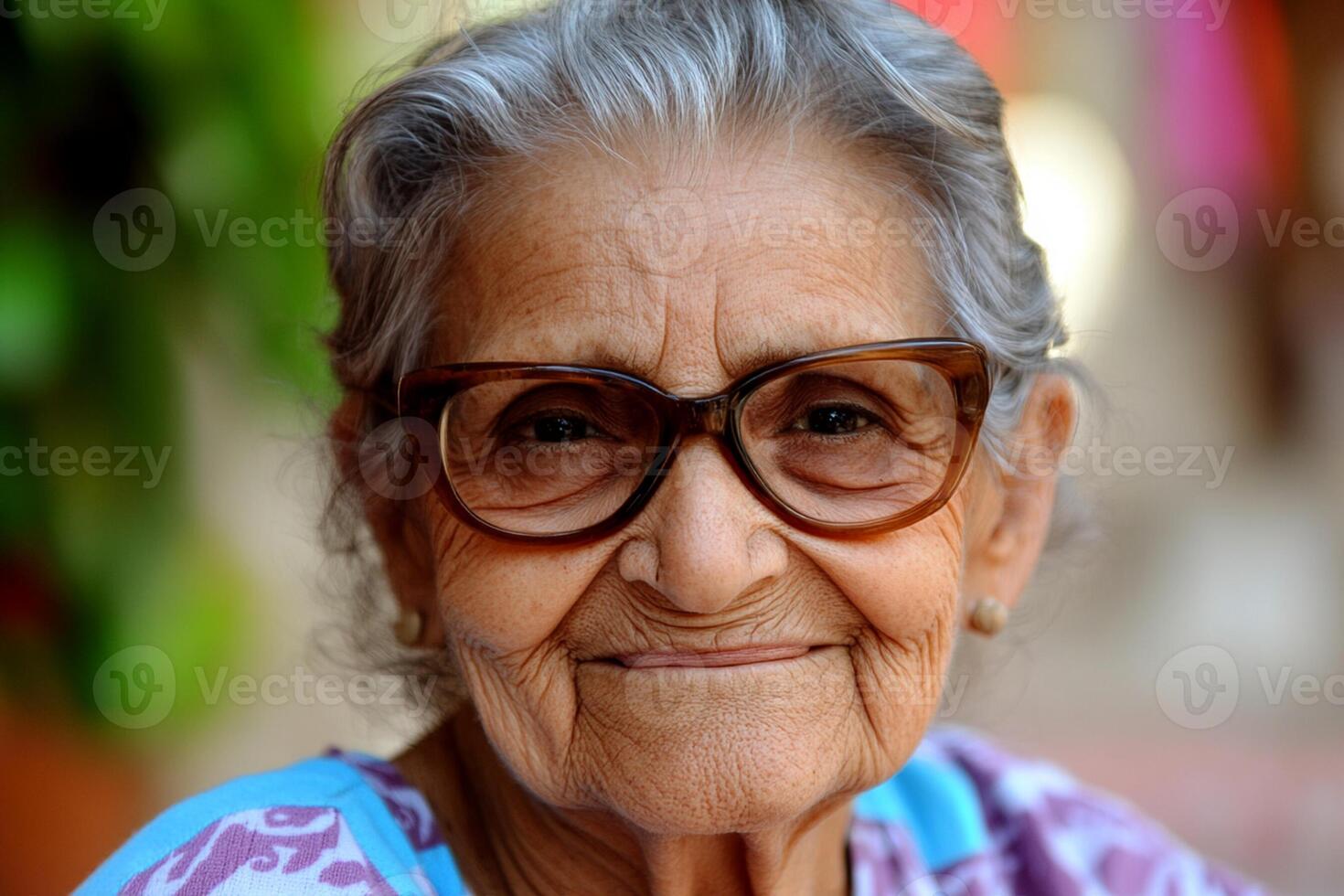 An older woman with glasses on smiling photo