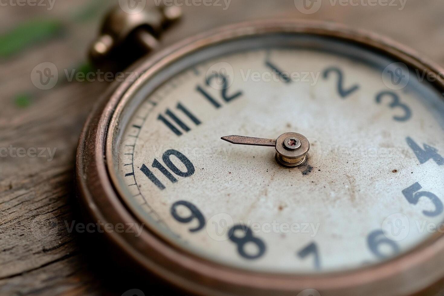 A close up of a clock on a wooden table photo