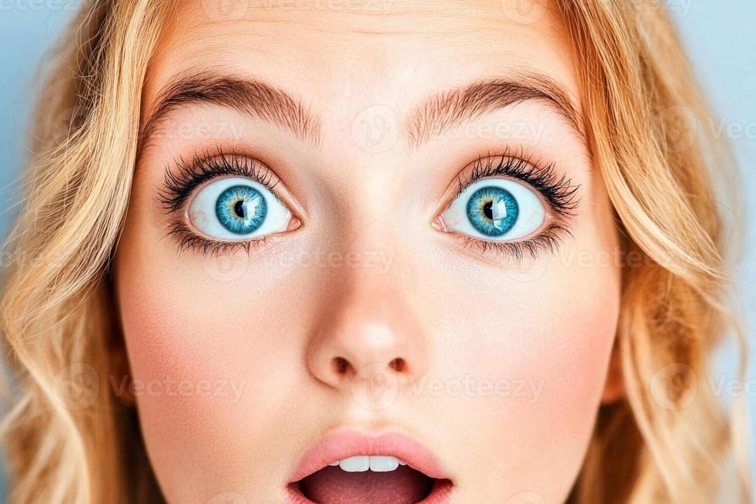 A woman with blue eyes looking surprised photo
