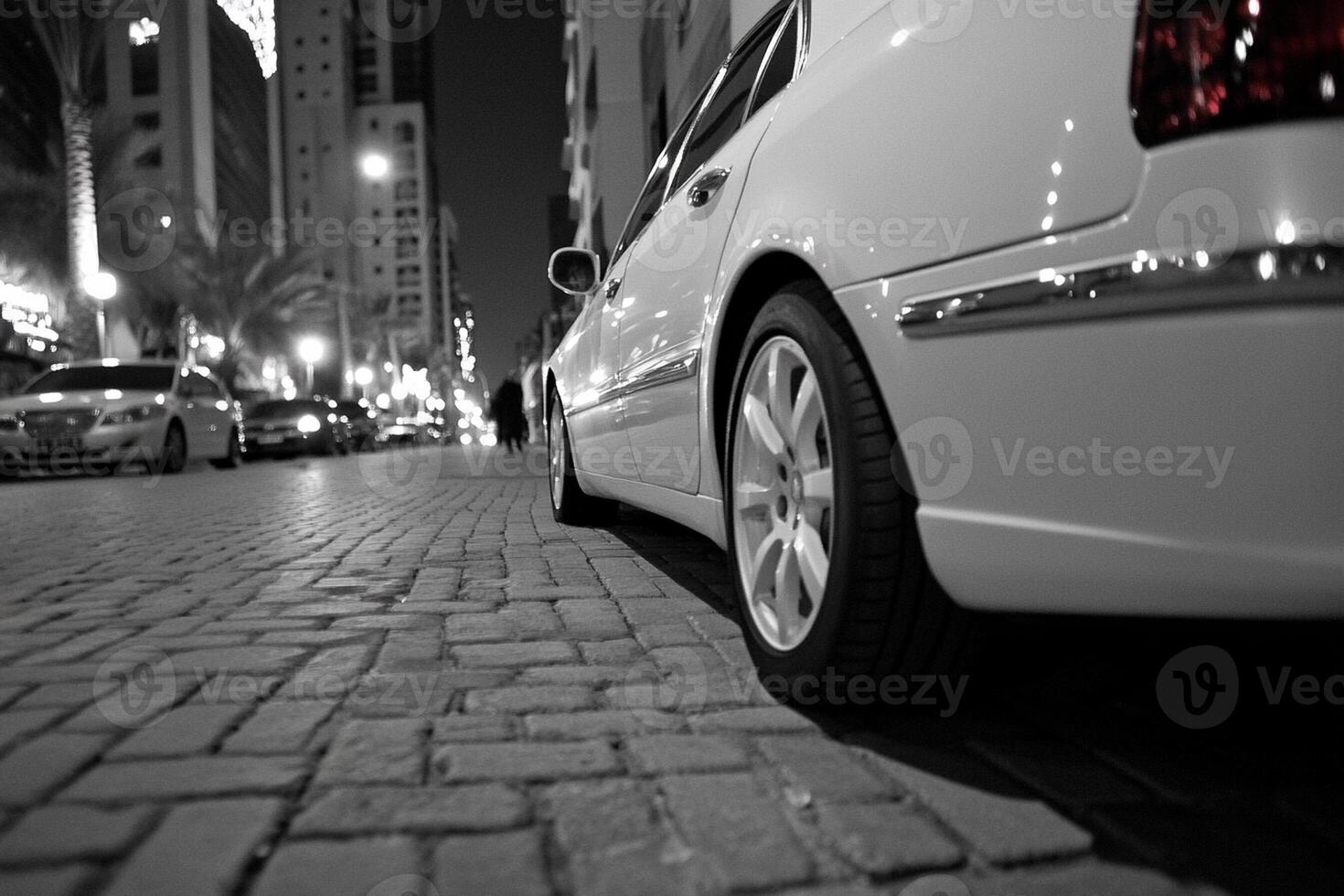 A black and white photo of a car parked on a street