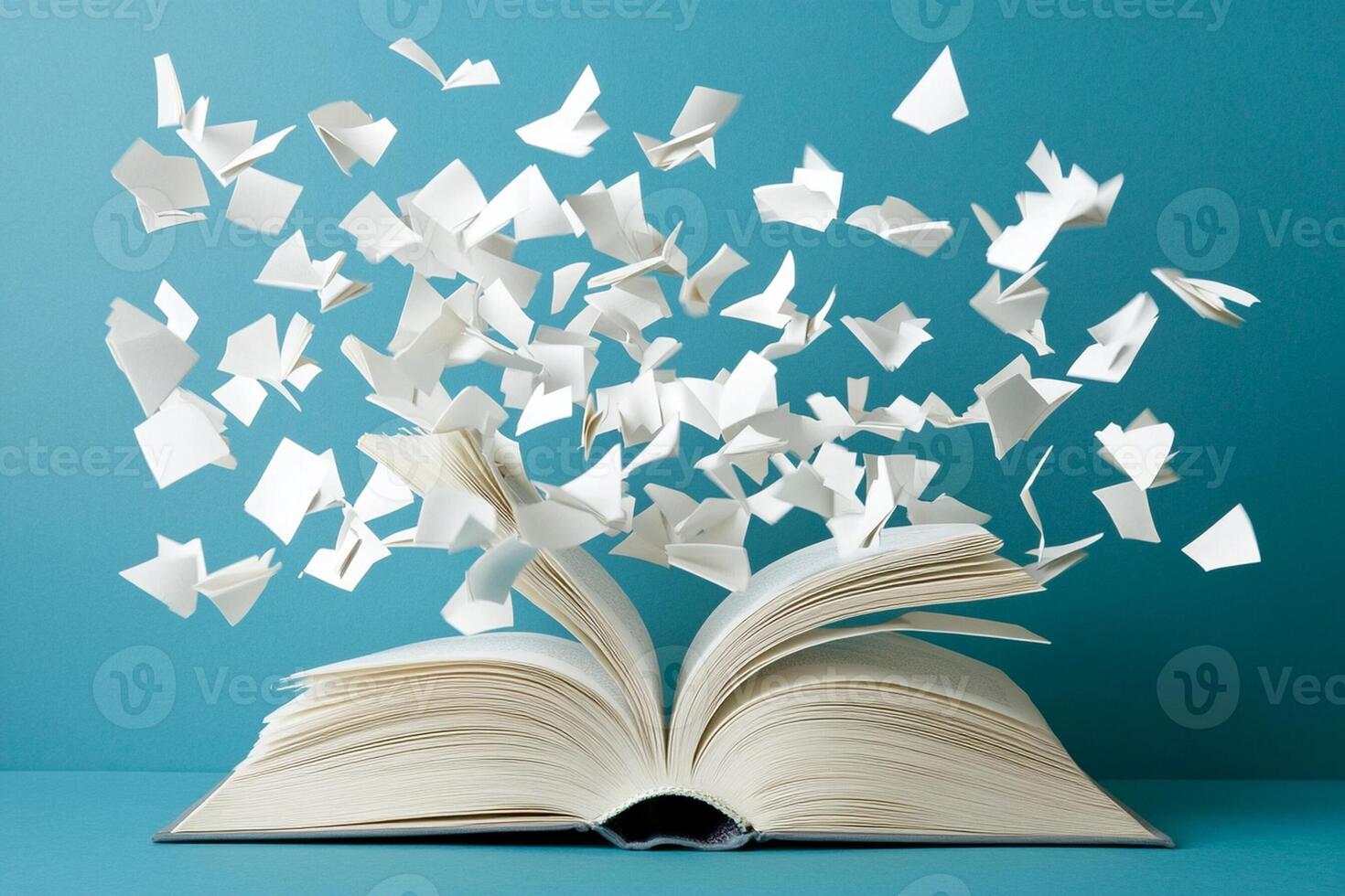 An open book with white paper flying out of it photo