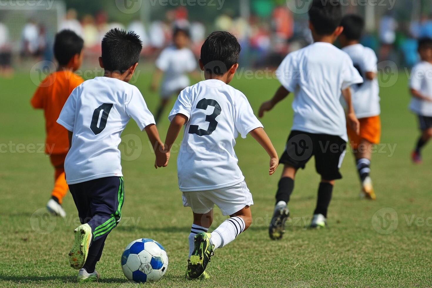A group of young boys playing soccer on a field photo