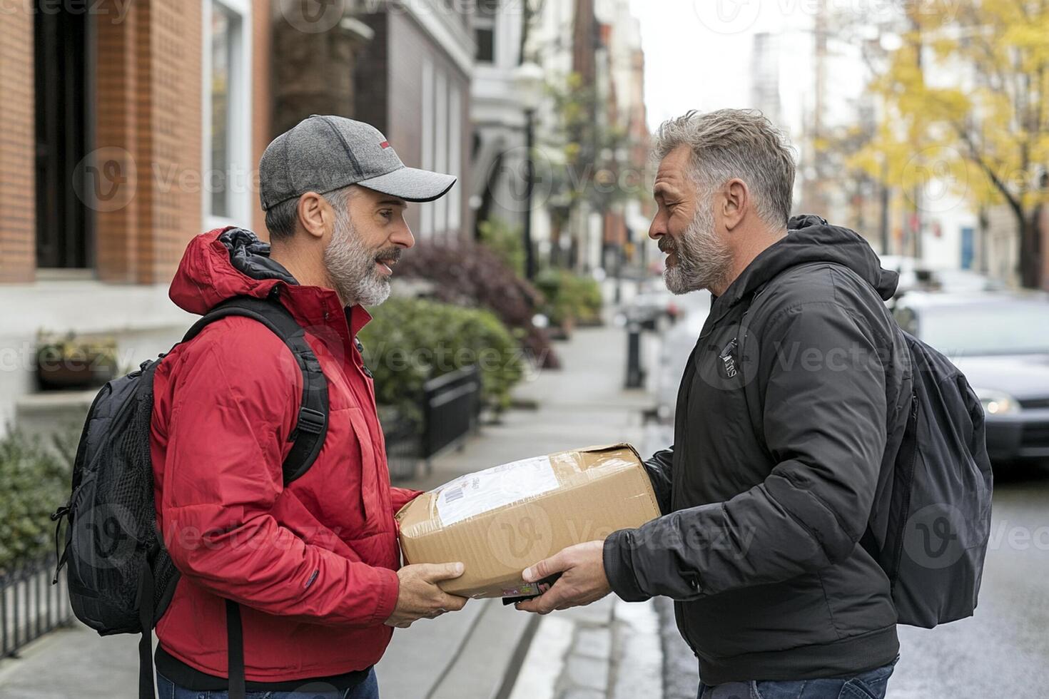 Two men are standing on the street holding packages photo