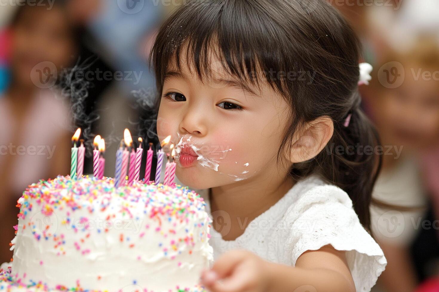 A little girl blowing out candles on a cake photo