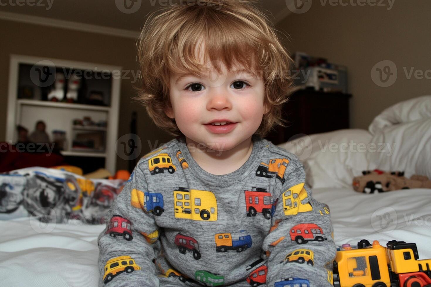 A little boy sitting on a bed photo