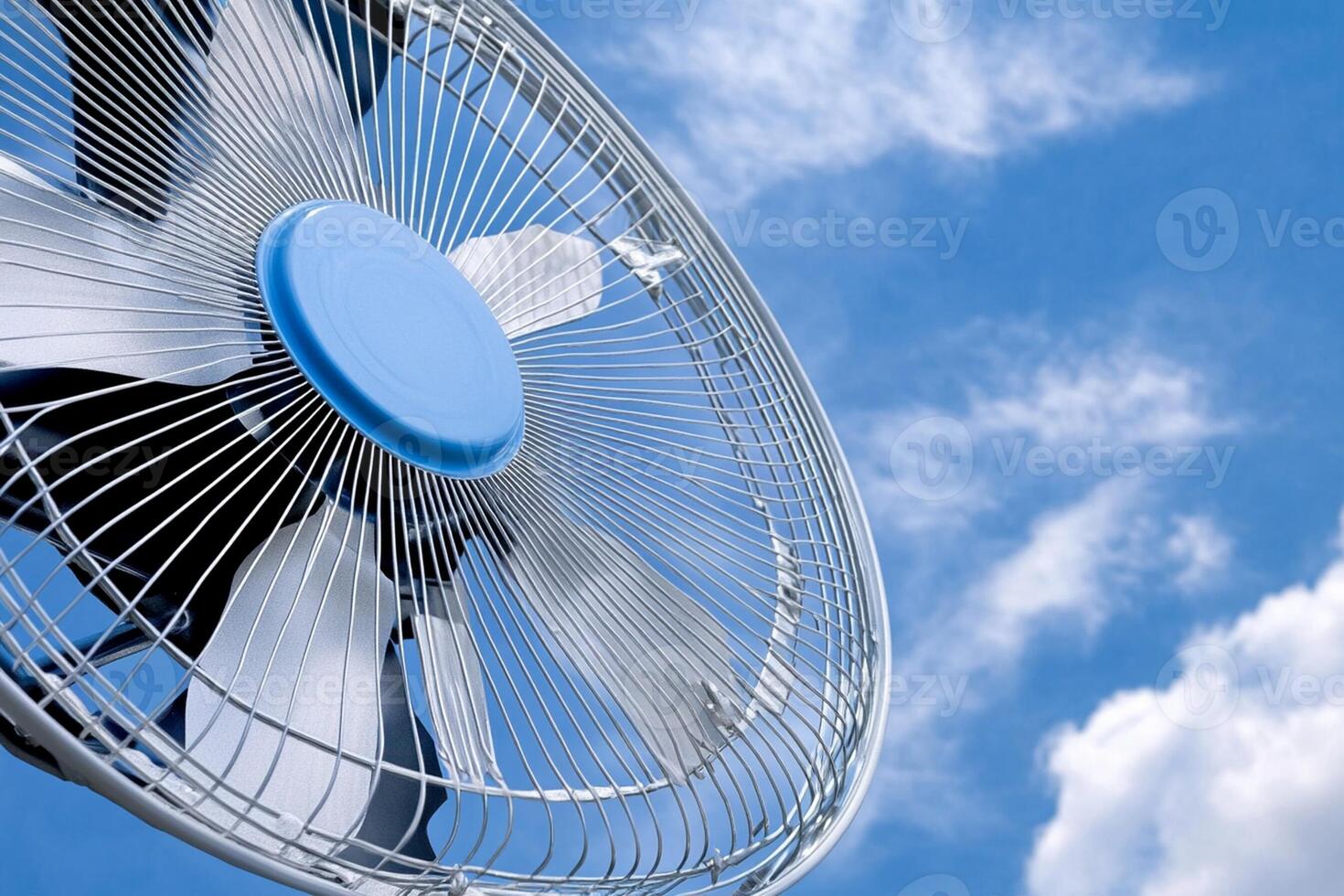 A close up of a fan with blue sky in the background photo