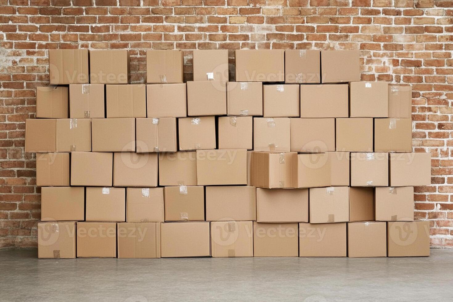 A large pile of cardboard boxes in front of a brick wall photo
