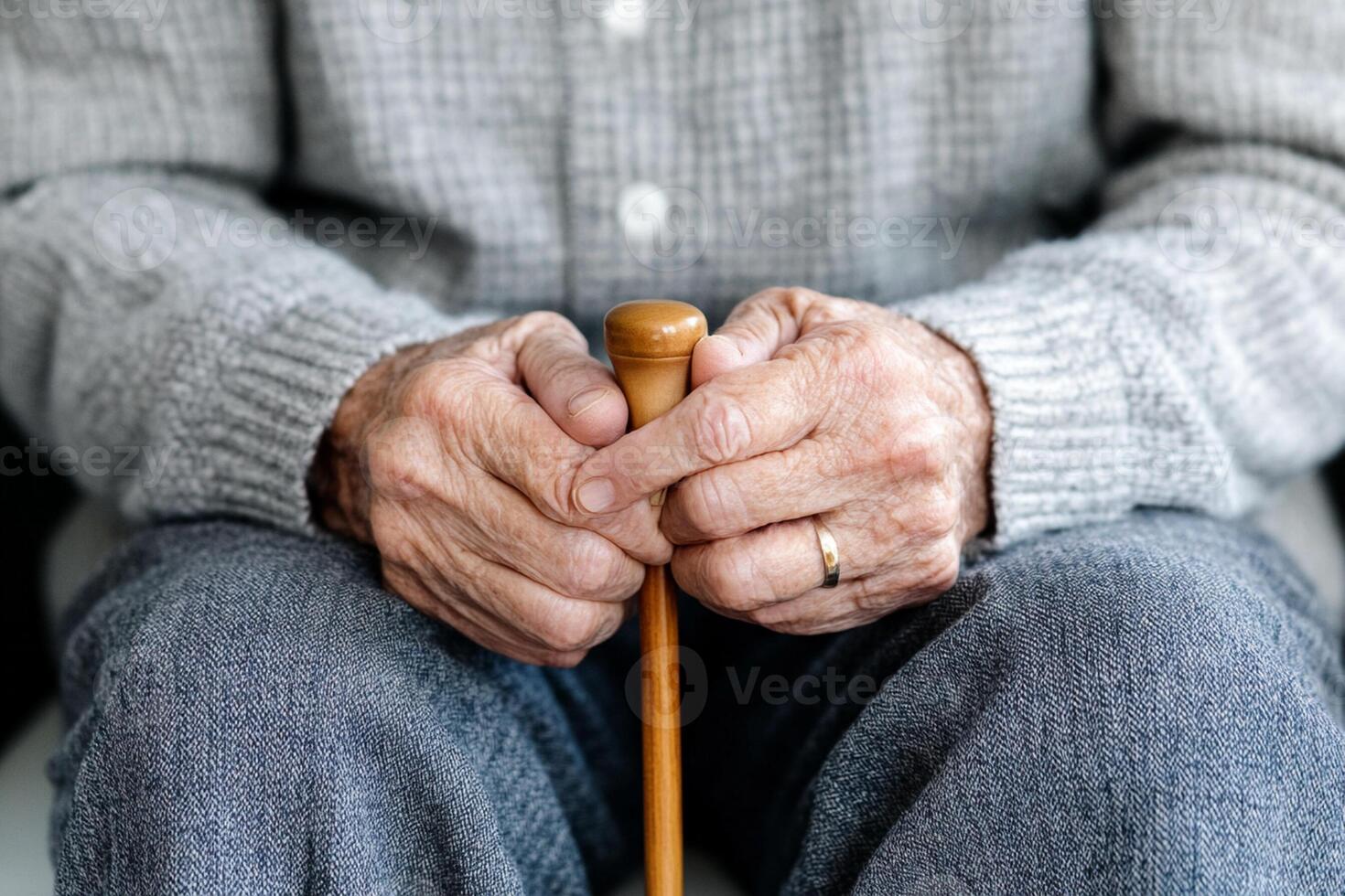 An elderly man holding a walking stick photo