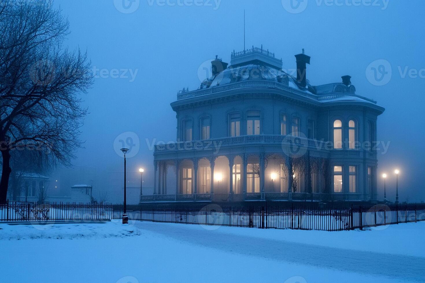 A large house in the snow with a light on photo