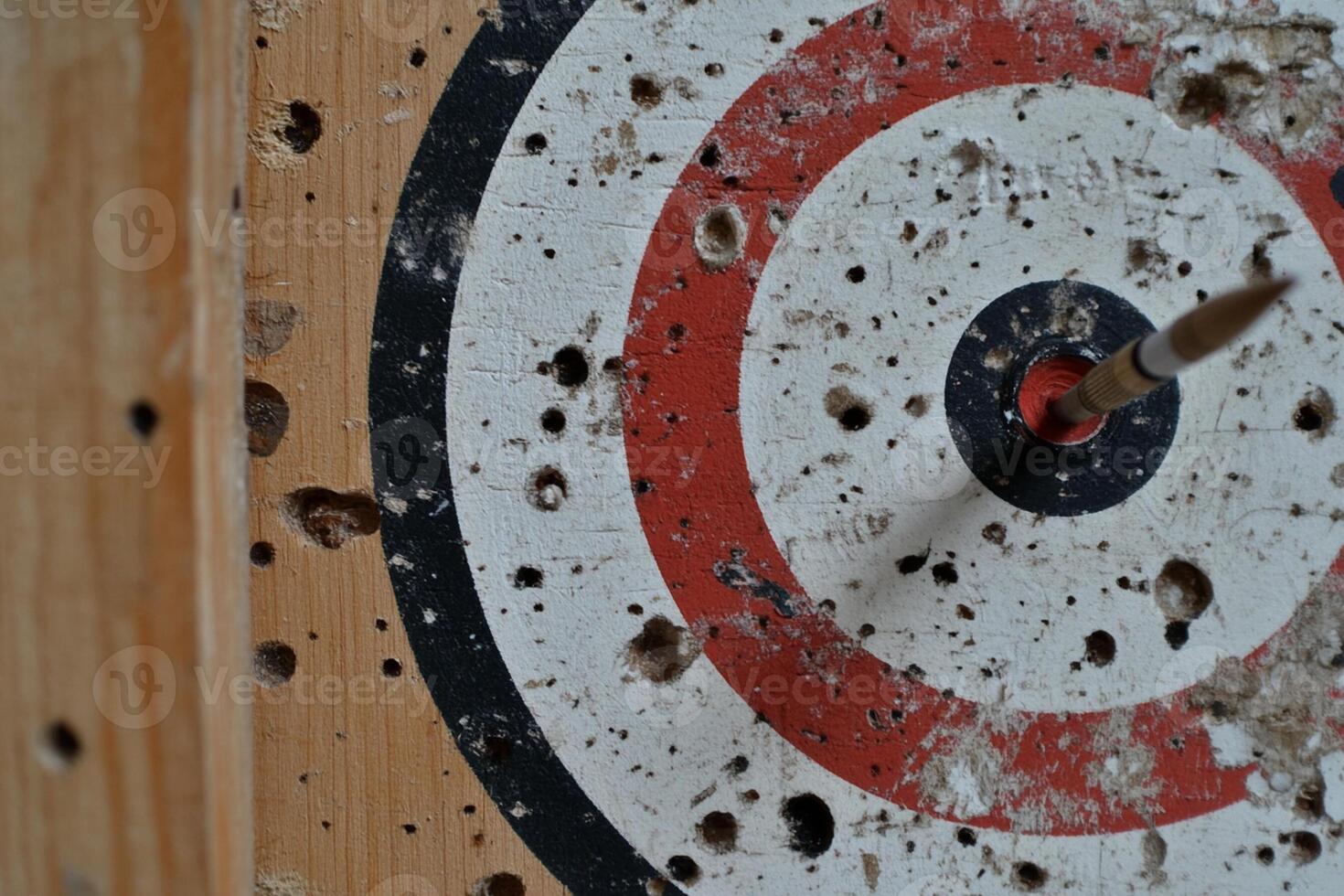 A close up of a dart hitting a target photo
