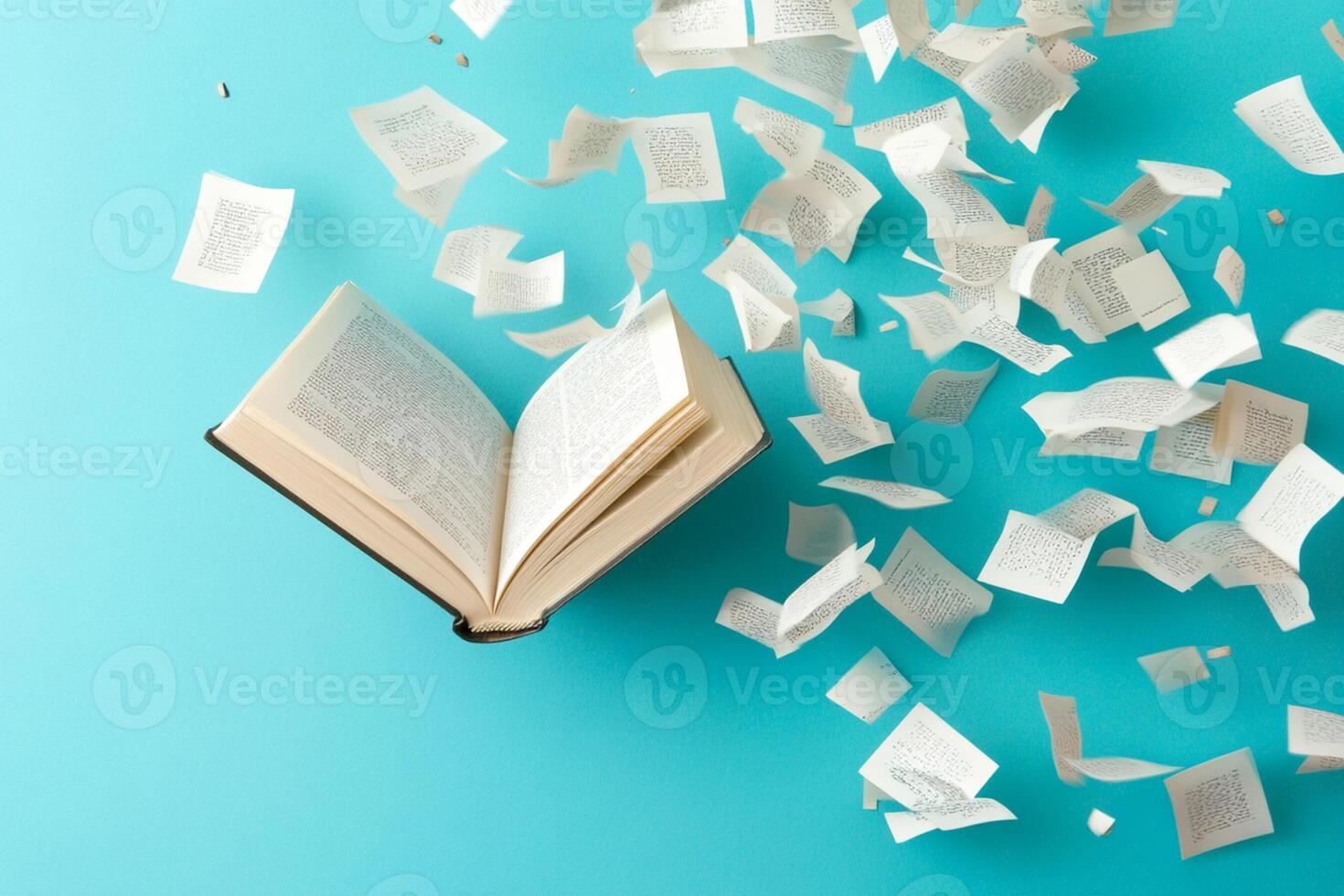 Open book with paper flying around on blue background photo