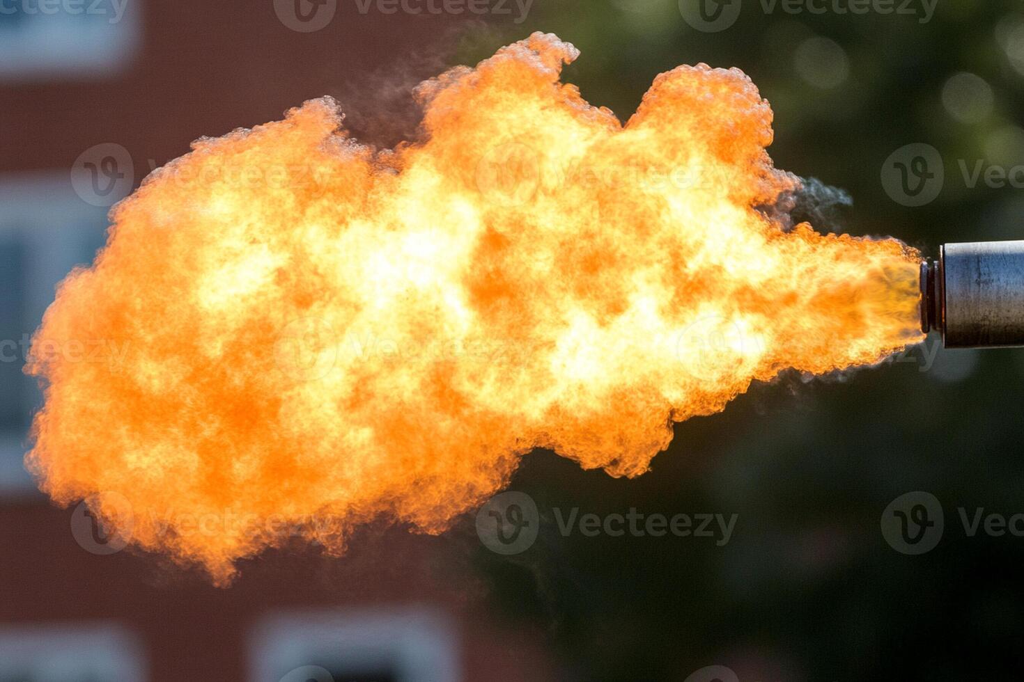 A fire hose is being used to spray out an orange flame photo