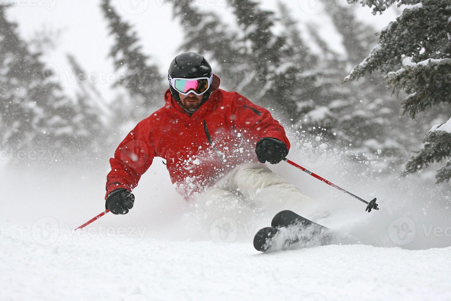 A man in a red jacket skiing down a snow covered slope photo