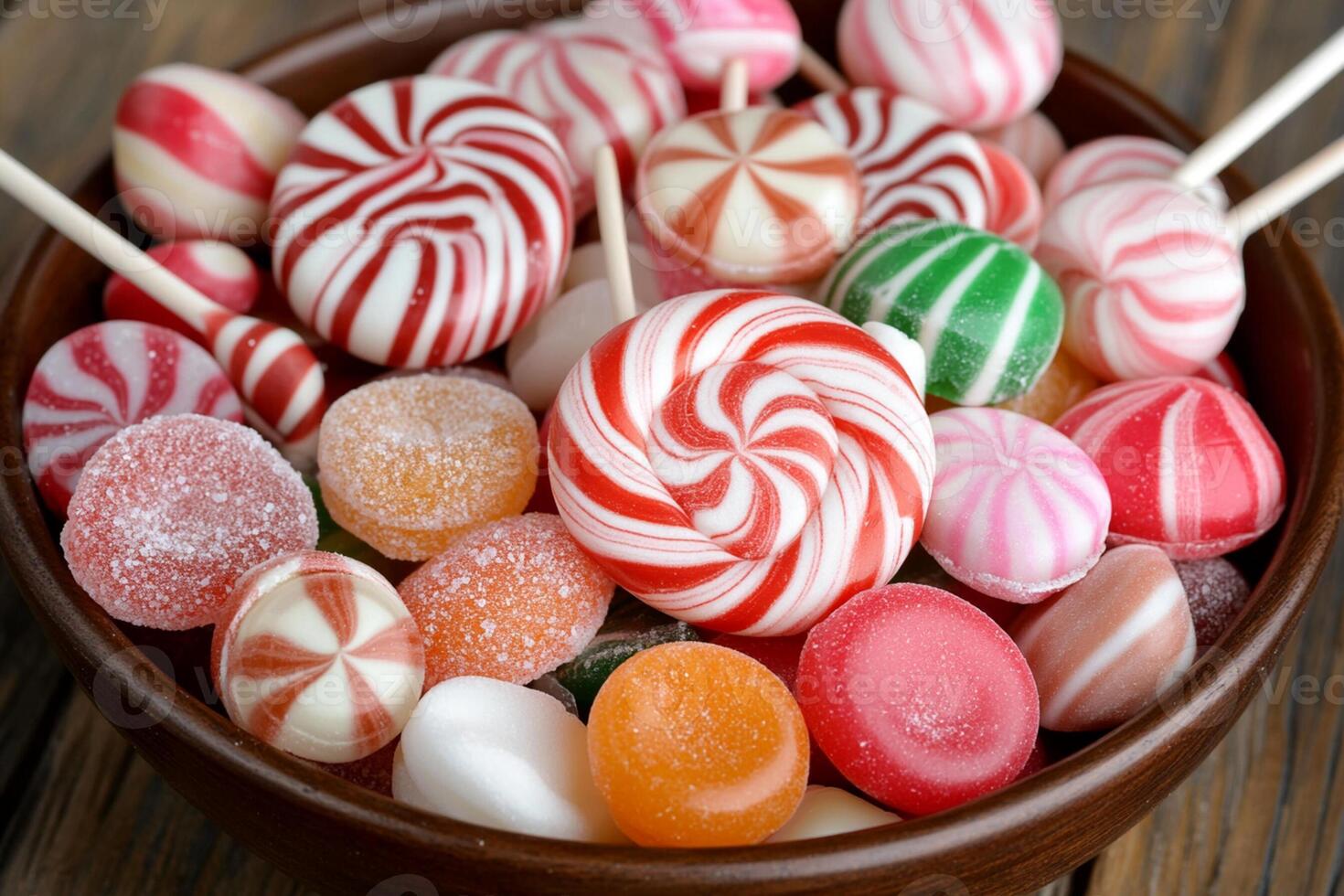 A bowl filled with candy lollipops photo