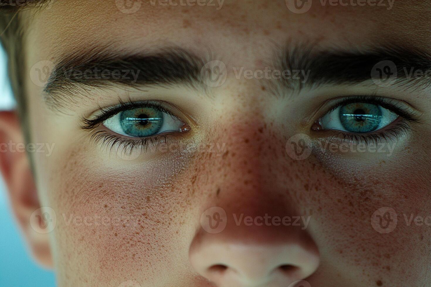 A close up of a young man's face with freckles photo