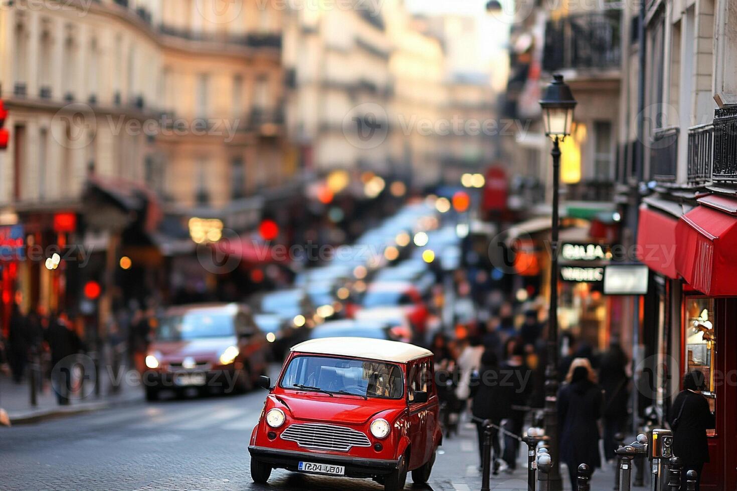A red car driving down a busy street photo